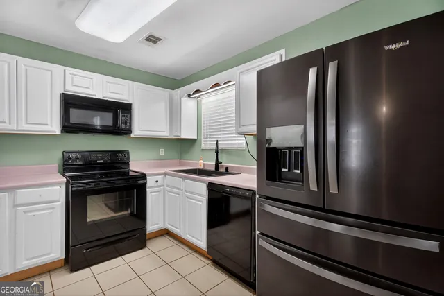 a kitchen with granite countertop stainless steel appliances and sink