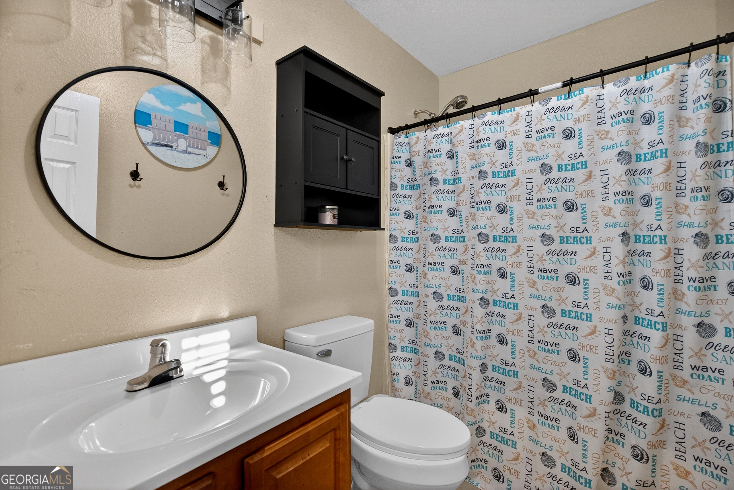 109 Garfield Street LaGrange, GA 30240 - Photo 8 of 14 a bathroom with a sink a toilet and a mirror