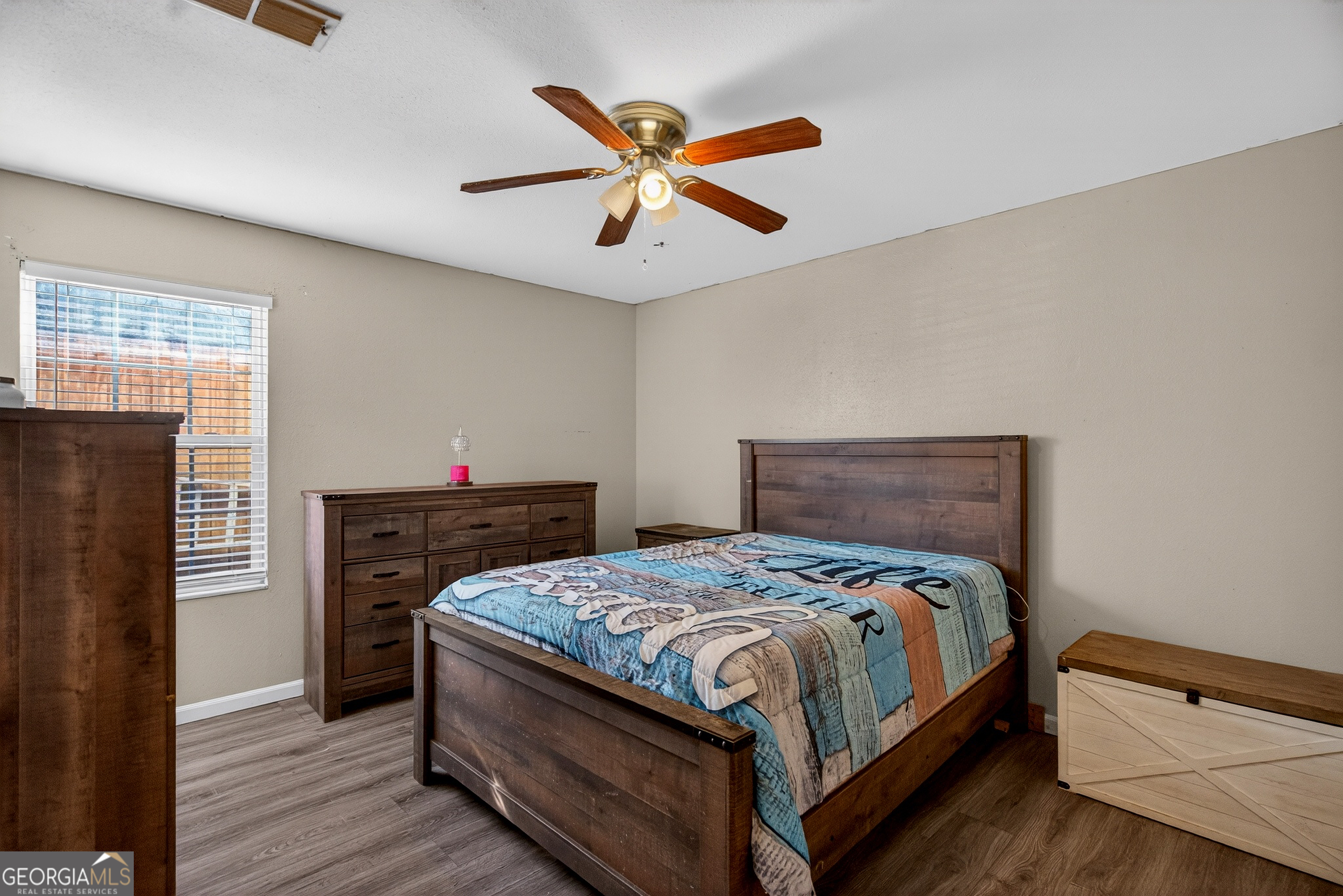 109 Garfield Street LaGrange, GA 30240 - Photo 9 of 14 a bedroom with a bed and a chandelier