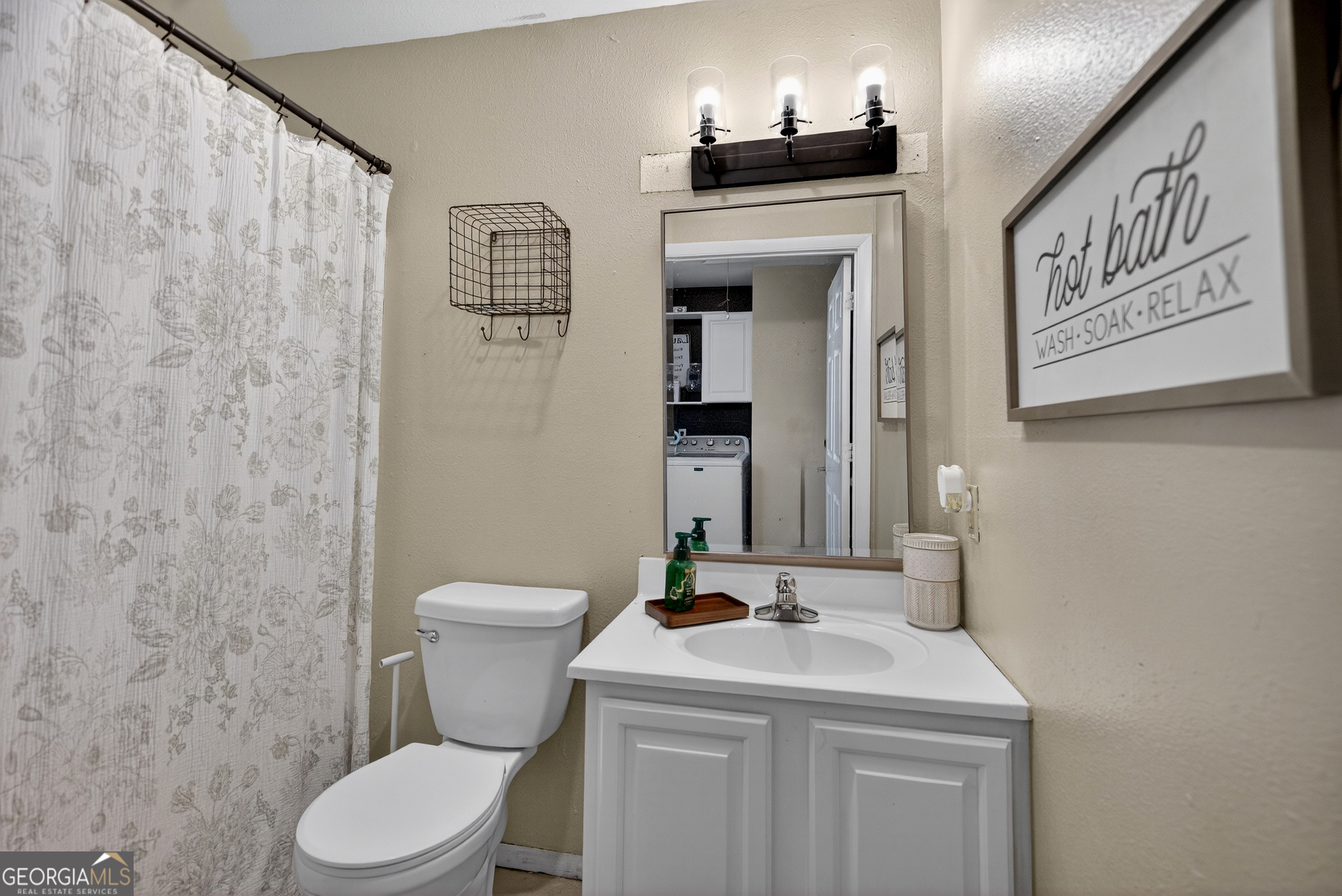 109 Garfield Street LaGrange, GA 30240 - Photo 10 of 14 a bathroom with a toilet sink and mirror