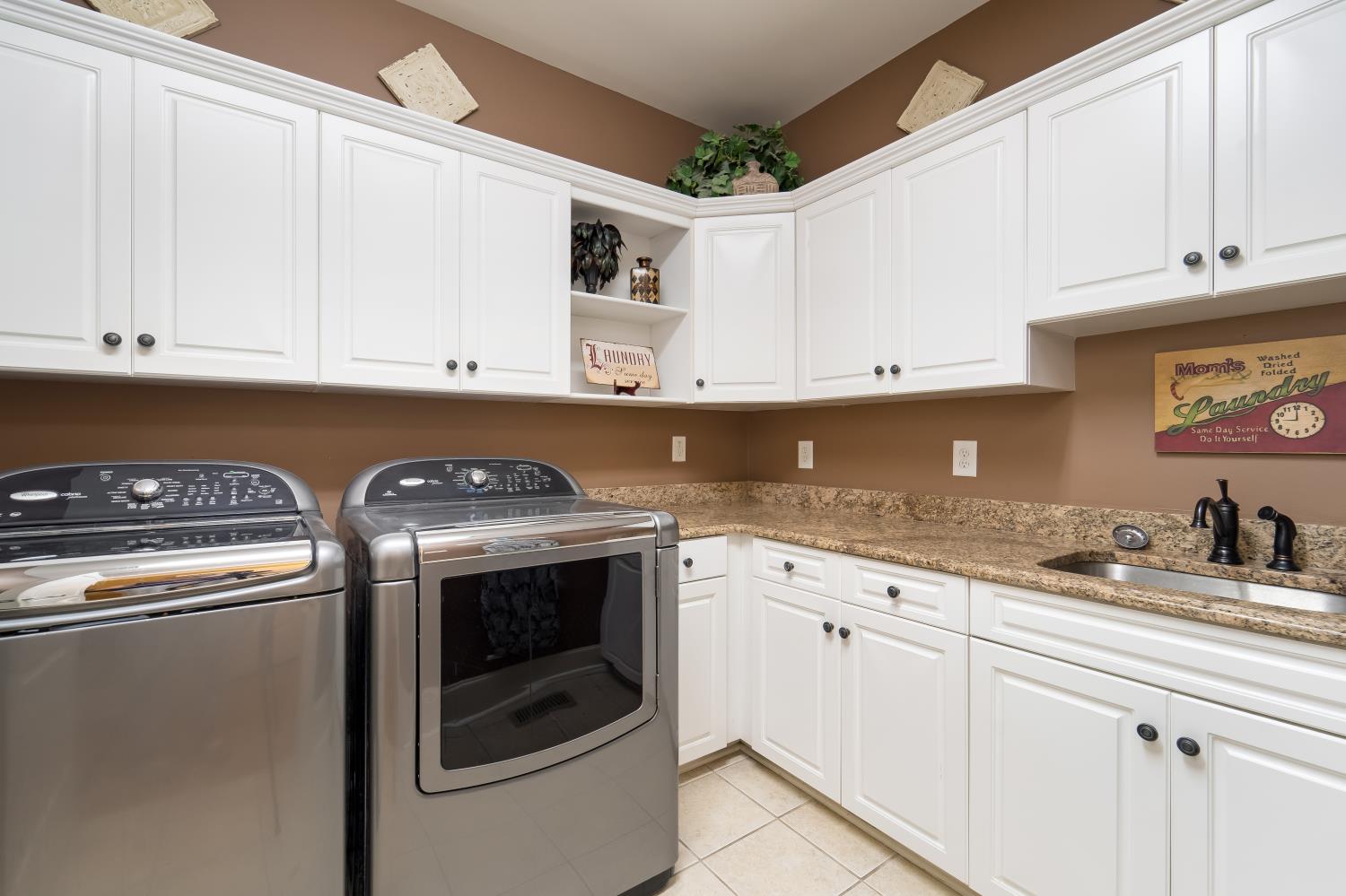 1621 Fair House Road Spring Hill, TN 37174 - Photo 19 of 30 a kitchen with granite countertop white cabinets and white appliances