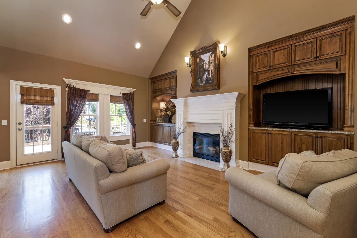 1621 Fair House Road Spring Hill, TN 37174 - Photo 3 of 30 a living room with furniture a flat screen tv and a fireplace
