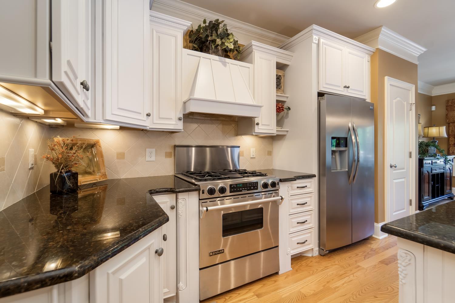 1621 Fair House Road Spring Hill, TN 37174 - Photo 7 of 30 a kitchen with stainless steel appliances granite countertop a sink a stove and a refrigerator