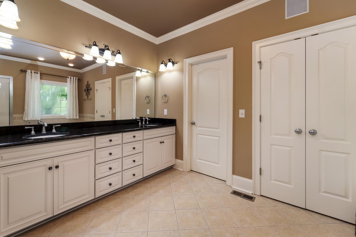 1621 Fair House Road Spring Hill, TN 37174 - Photo 10 of 30 a bathroom with a double vanity sink and a mirror
