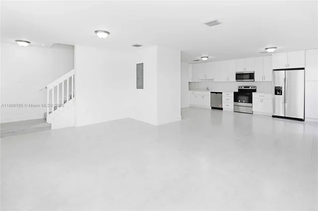 a view of a room with wooden floor