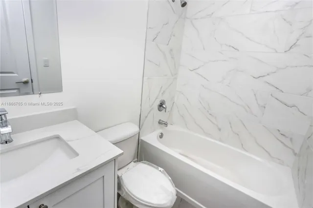 a kitchen with a white cabinets and sink