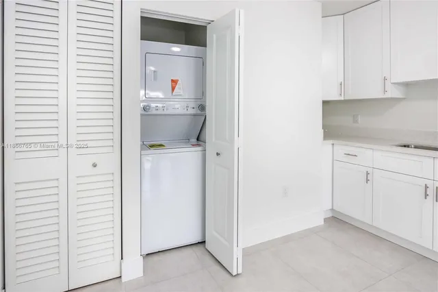 a view of kitchen with refrigerator and window