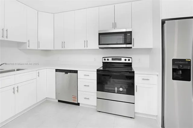 a utility room with a sink a toilet and vanity