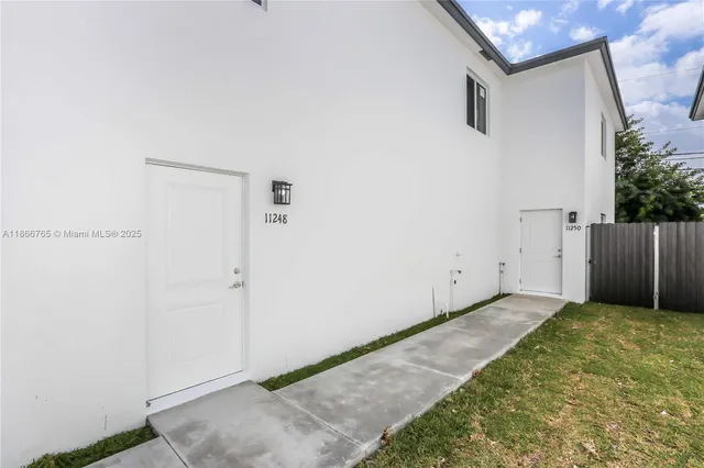 a view of a backyard with wooden fence