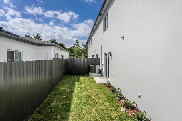 an aerial view of a house with a yard and swimming pool