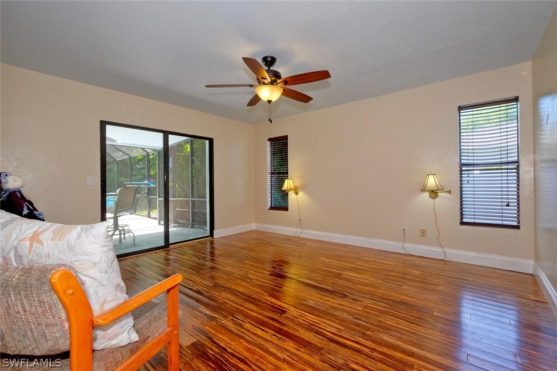17485 Oriole Road Fort Myers, FL 33967 - Photo 18 of 35 a view of an empty room with window and wooden floor