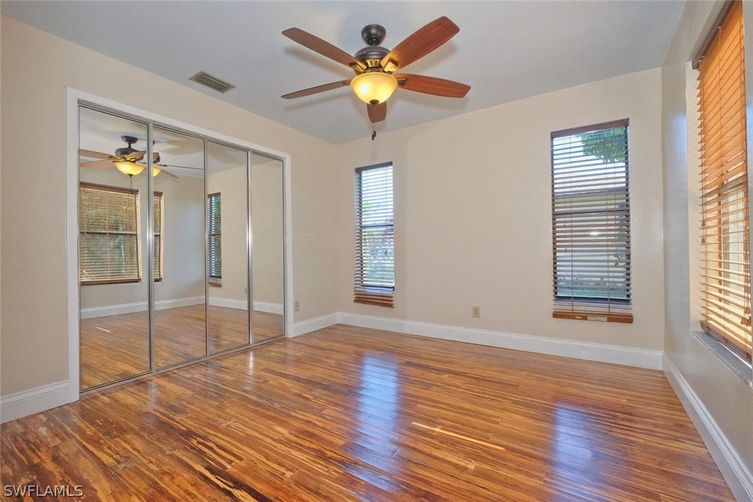 17485 Oriole Road Fort Myers, FL 33967 - Photo 24 of 35 a view of an empty room with window and wooden floor
