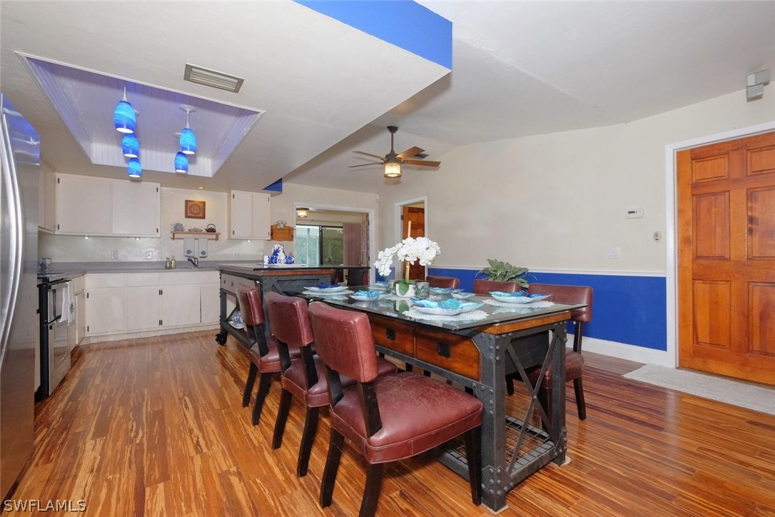 17485 Oriole Road Fort Myers, FL 33967 - Photo 10 of 35 a kitchen with stainless steel appliances granite countertop a dining table chairs and wooden floor