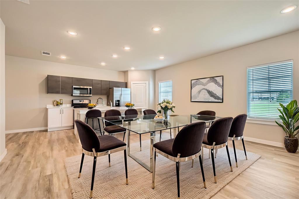 4425 Lassen Trail Forney, TX 75126 - Photo 3 of 6 a view of a dining room with furniture window and wooden floor