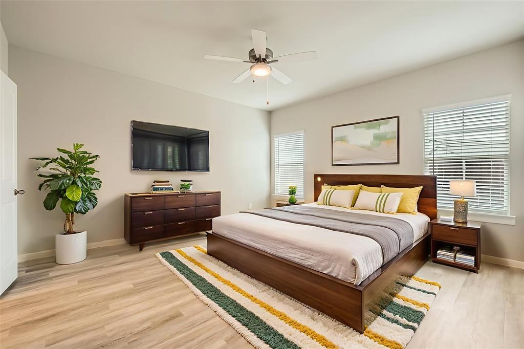 4425 Lassen Trail Forney, TX 75126 - Photo 4 of 6 a bedroom with a bed potted plant and a flat screen tv