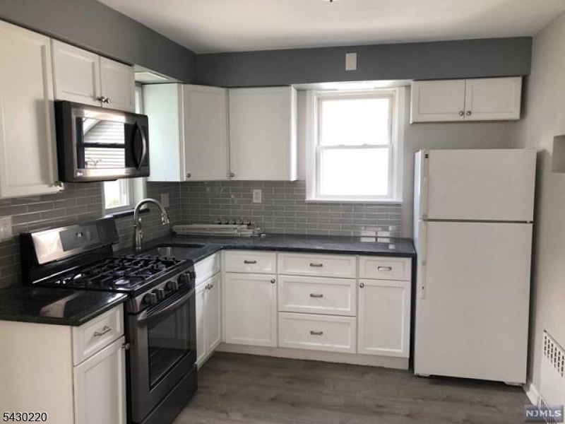 166 Carmita Avenue Rutherford, NJ 07070 - Photo 2 of 27 a kitchen with granite countertop white cabinets and stainless steel appliances