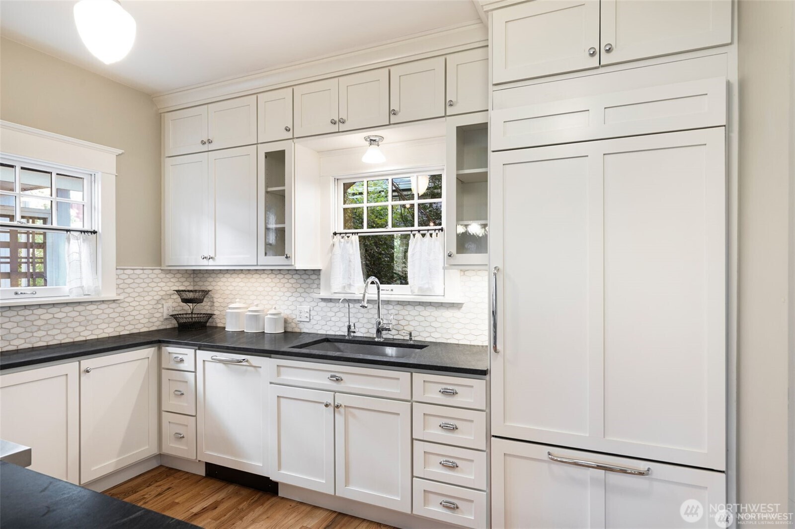 2430 8th Avenue West Seattle, WA 98119 - Photo 11 of 34 a kitchen with granite countertop white cabinets and white appliances