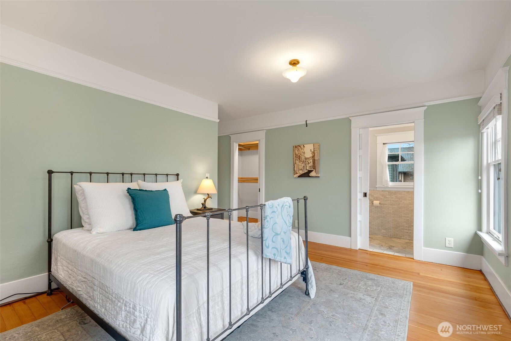 2430 8th Avenue West Seattle, WA 98119 - Photo 18 of 34 a bed room with a bed and wooden floor