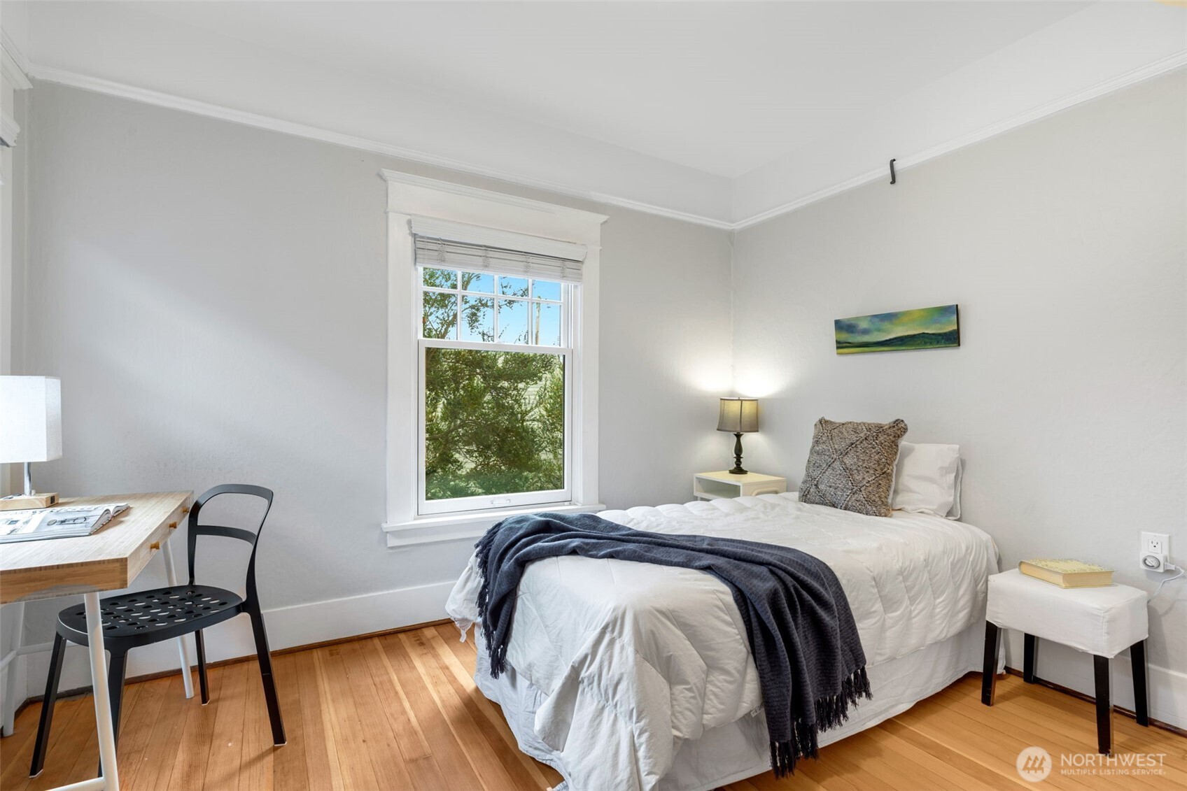 2430 8th Avenue West Seattle, WA 98119 - Photo 23 of 34 a bedroom with a bed a chair and a potted plant