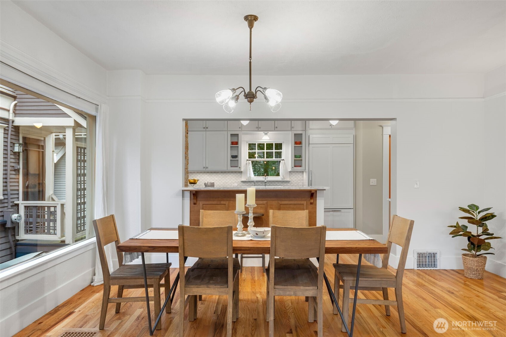 2430 8th Avenue West Seattle, WA 98119 - Photo 8 of 34 a dining room with furniture a chandelier and wooden floor