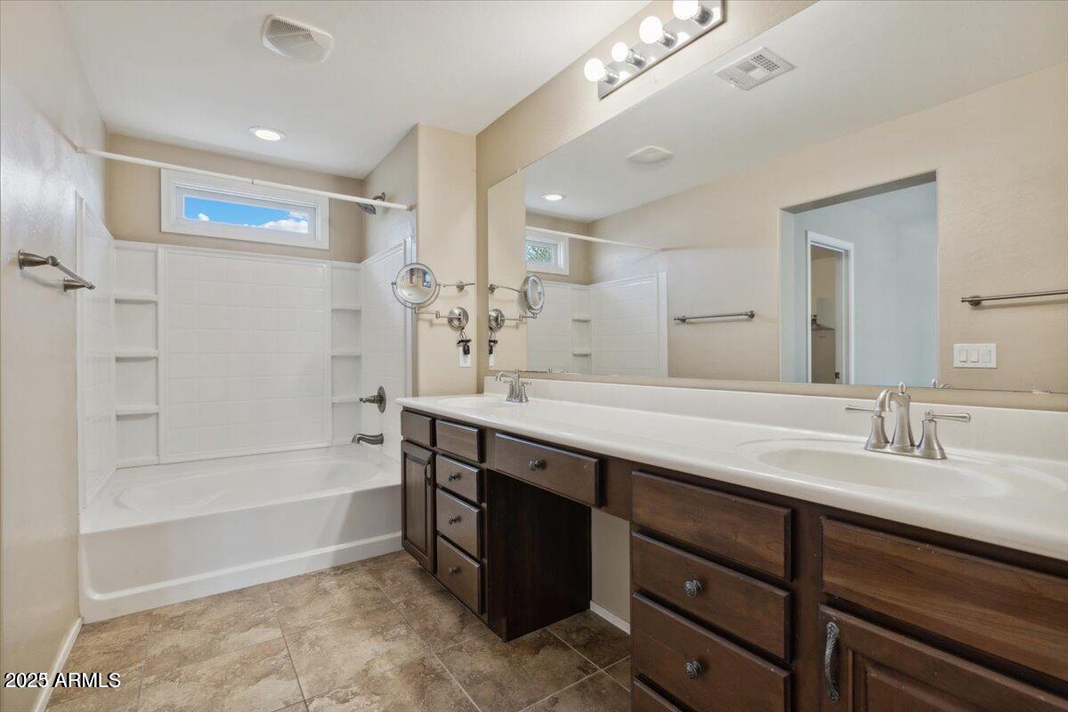 2233 East Pecan Road Phoenix, AZ 85040 - Photo 11 of 18 a spacious bathroom with a tub sink shower and mirror