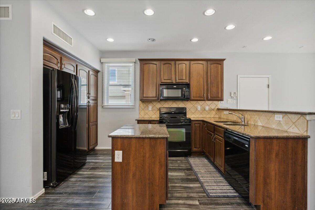 2233 East Pecan Road Phoenix, AZ 85040 - Photo 4 of 18 a kitchen with granite countertop a refrigerator stove and oven