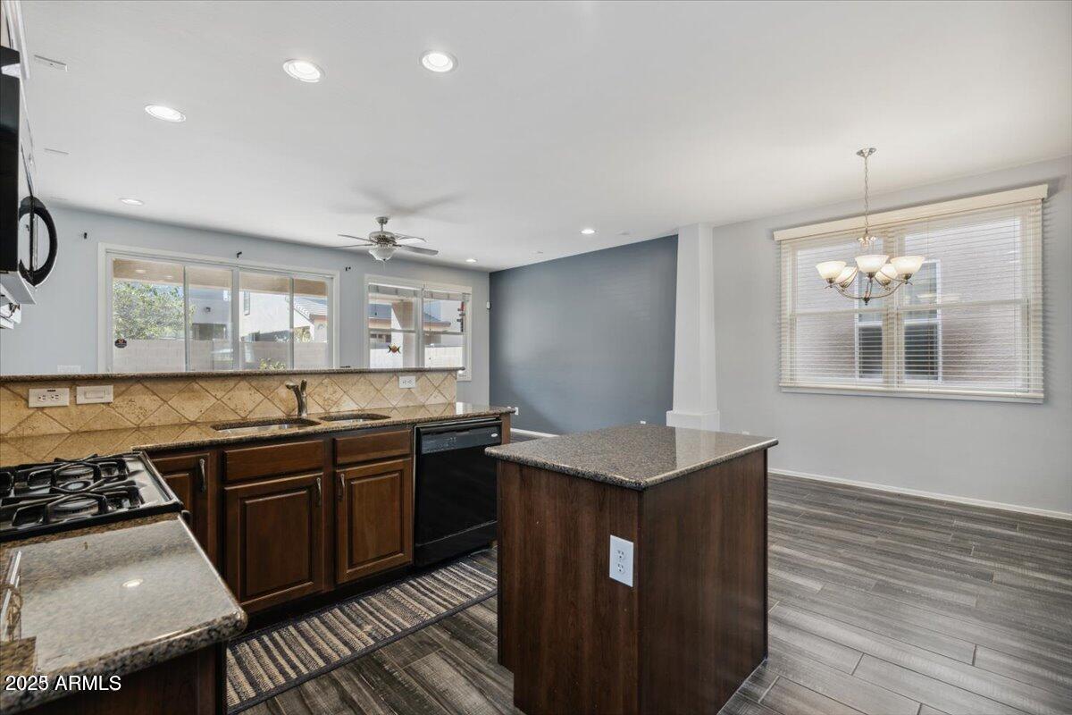 2233 East Pecan Road Phoenix, AZ 85040 - Photo 5 of 18 a kitchen with stainless steel appliances granite countertop a sink stove and wooden floor