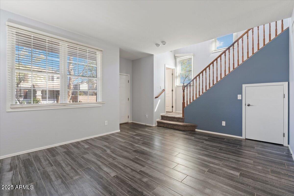 2233 East Pecan Road Phoenix, AZ 85040 - Photo 7 of 18 a view of an empty room with wooden floor and a window