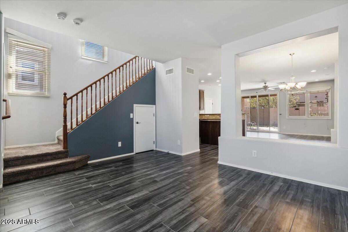 2233 East Pecan Road Phoenix, AZ 85040 - Photo 8 of 18 a view of an empty room with wooden floor and a window