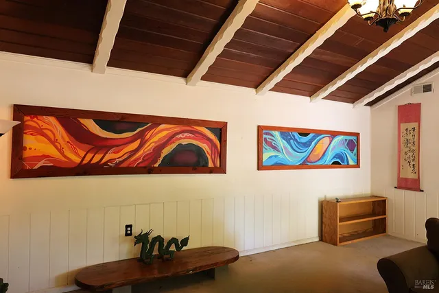 a kitchen with stainless steel appliances a sink a stove a refrigerator cabinets and a window