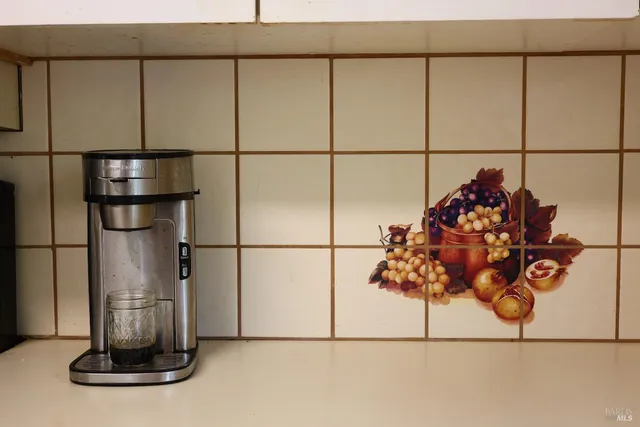a view of a dining room with furniture and a chandelier fan