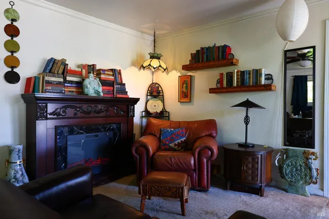 a view of a workspace with furniture and a window