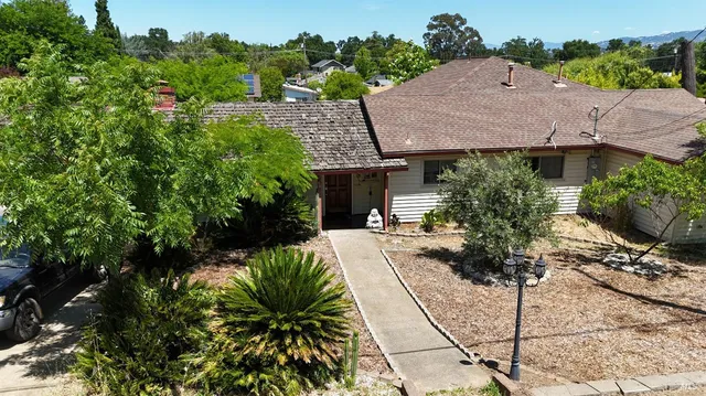 a view of a house with a small yard and plants
