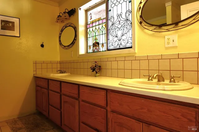 a view of a patio with table and chairs potted plants with wooden floor and fence