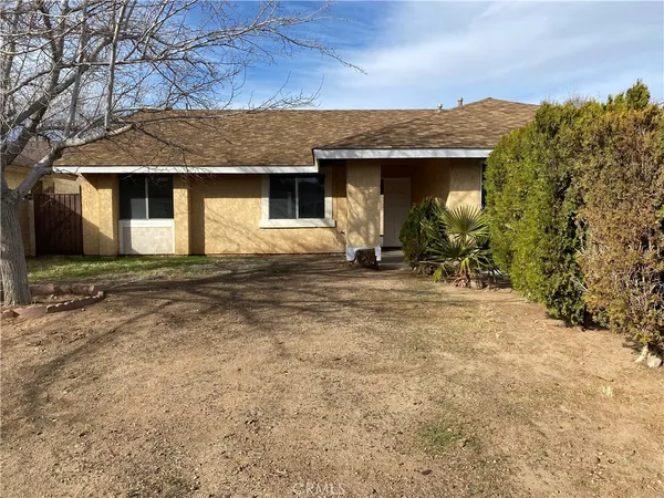 a front view of a house with yard