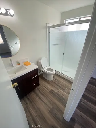 a bathroom with a double vanity sink toilet and shower