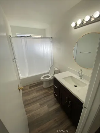 a bathroom with a sink toilet and mirror