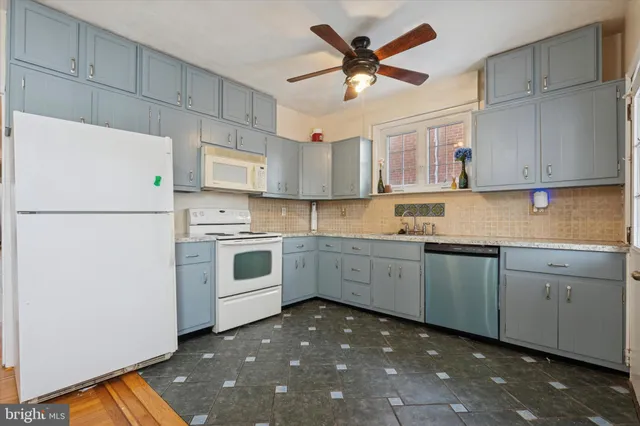 a kitchen with a table chairs and a refrigerator