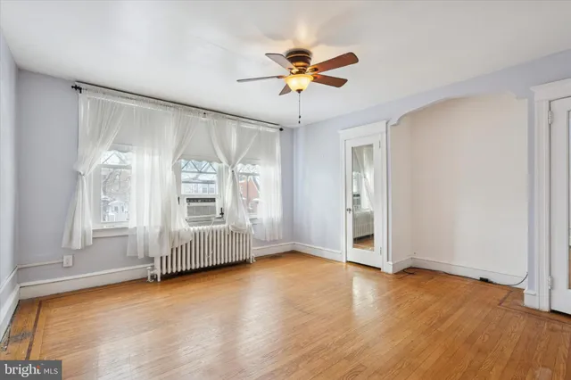 a view of an empty room with a ceiling fan