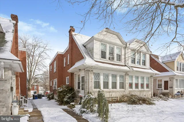 a front view of a residential apartment building with a yard
