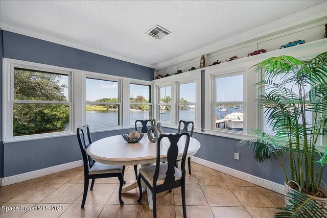 a kitchen with a table chairs sink and cabinets