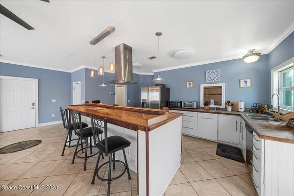 a kitchen with stainless steel appliances granite countertop a refrigerator and a sink