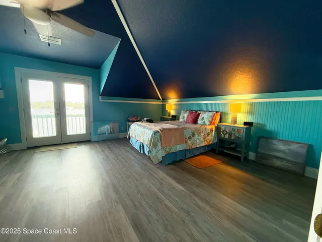 a view of a hall way with furniture and a window