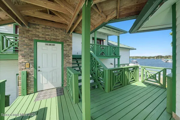 a view of balcony with wooden floor and fence