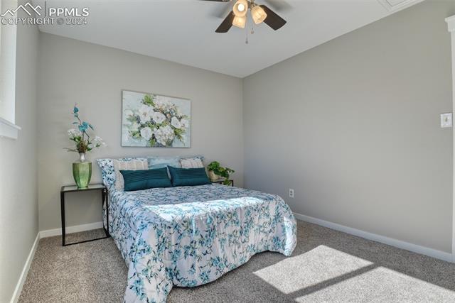 1913 Wooten Road Colorado Springs, CO 80915 - Photo 40 of 50 Bedroom with light carpet and ceiling fan
