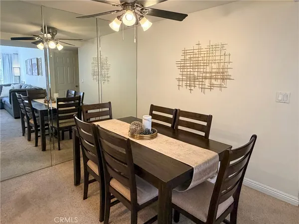 a view of a dining room with furniture and chandelier