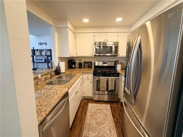 a kitchen with refrigerator a sink and cabinets