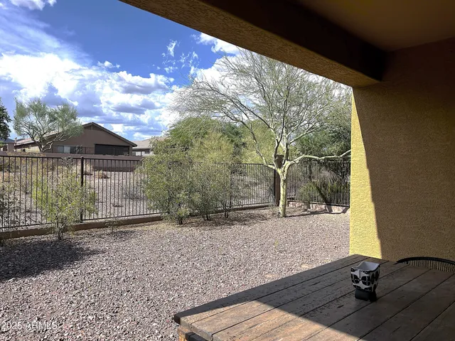 a view of house with backyard outdoor seating and hardwood
