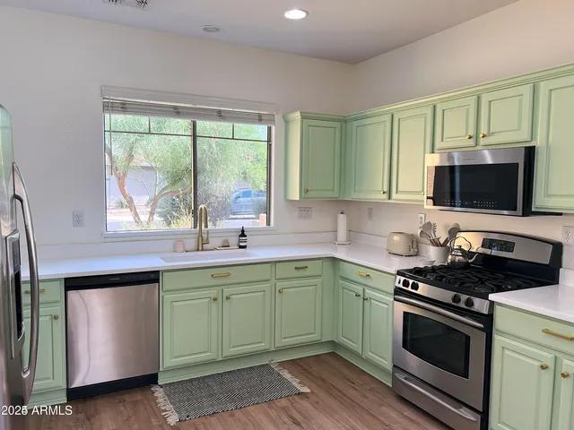 a kitchen with a sink stove top oven and microwave