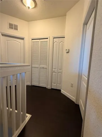 a bed sitting in a bedroom and lamp